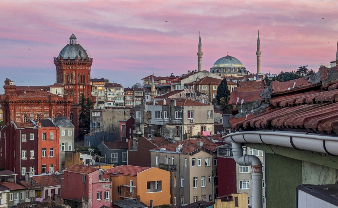 View of apartments and mosques in Istanbul taken from an upper story window.