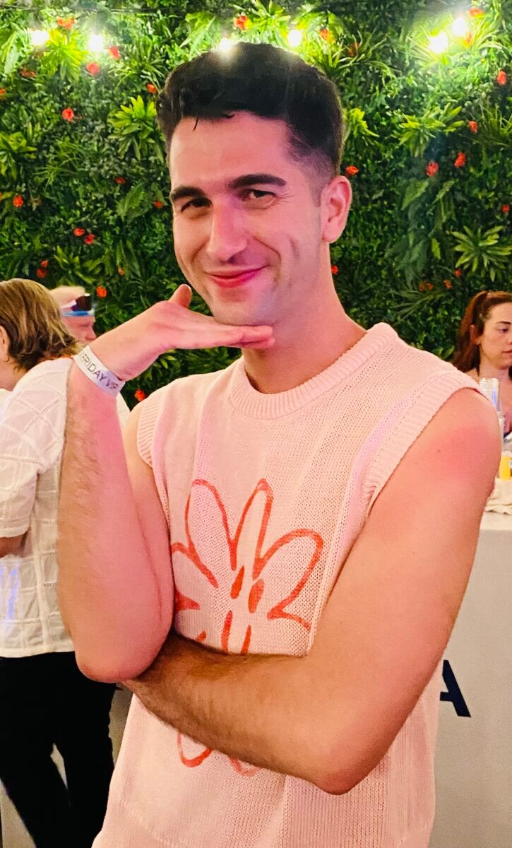 Spanish media personality David Pallares serving sass in a hippie-themed tank top.