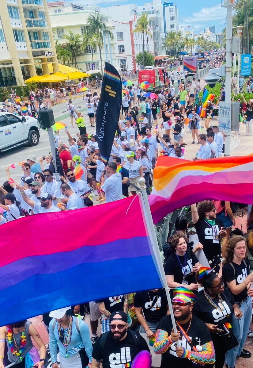 Miami Beach locals and tourists filling the streets to watch the parade and show off their pride.