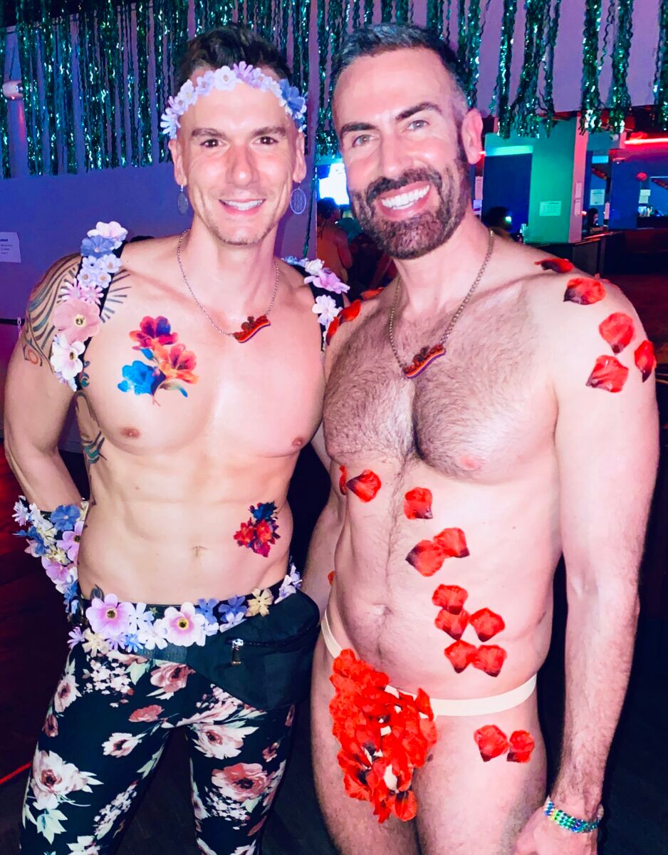 Glamcock BFFs Chris "Doctor" Hanner and John "Dare Pacheco" embracing Bloom's nature theme by paring flower petals with 6-pack abs.  