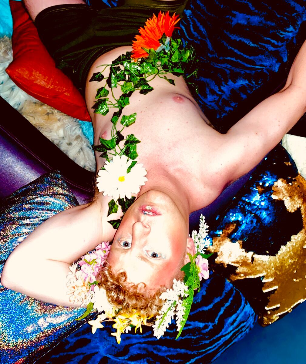 GlamTwink Nick Walker taking a break from the dance floor in Bloom's cuddle-puddle space.