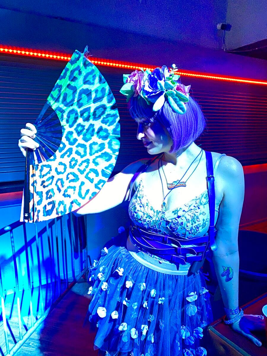 Kimbo cooling herself off on the dance floor with her animal print fan.