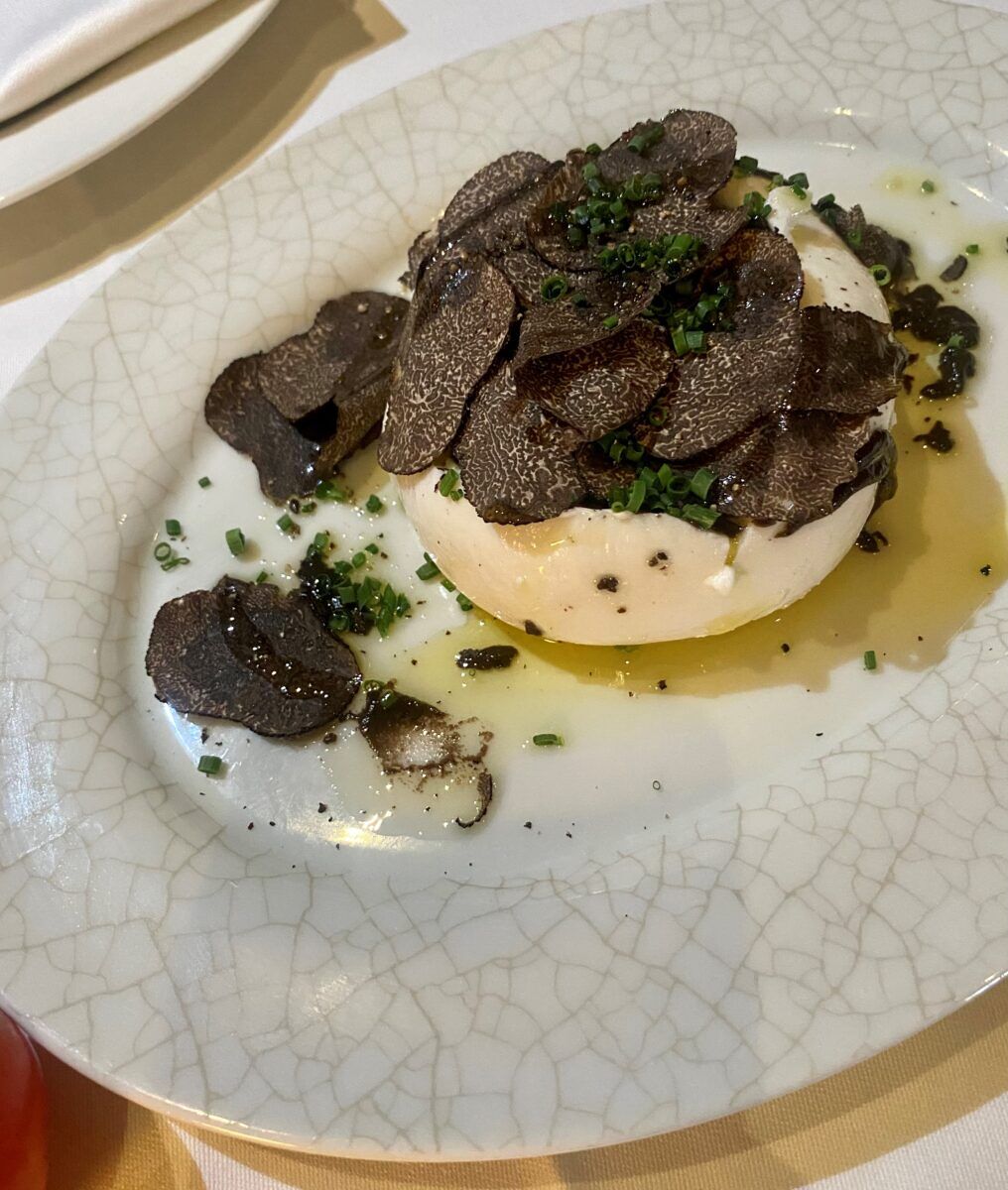 LPM's burrata prepared with heritage tomatoes and basil and topped with white truffles.
