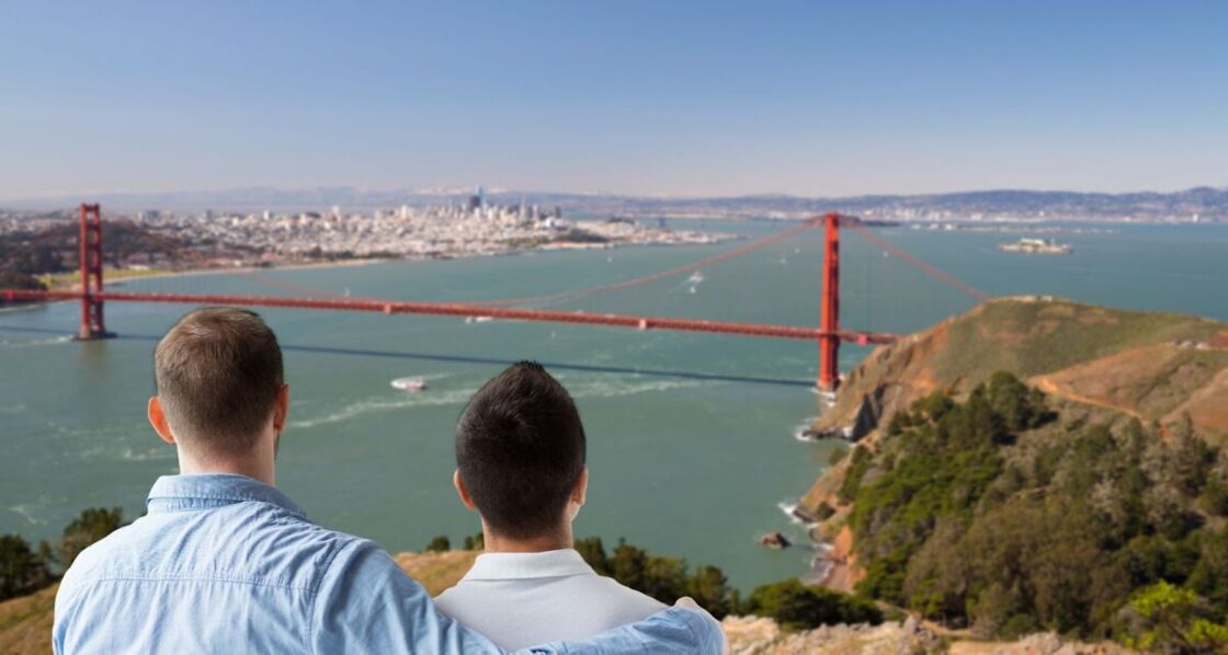 Two men look out over the San Francisco Bay at the San Francisco Bridge