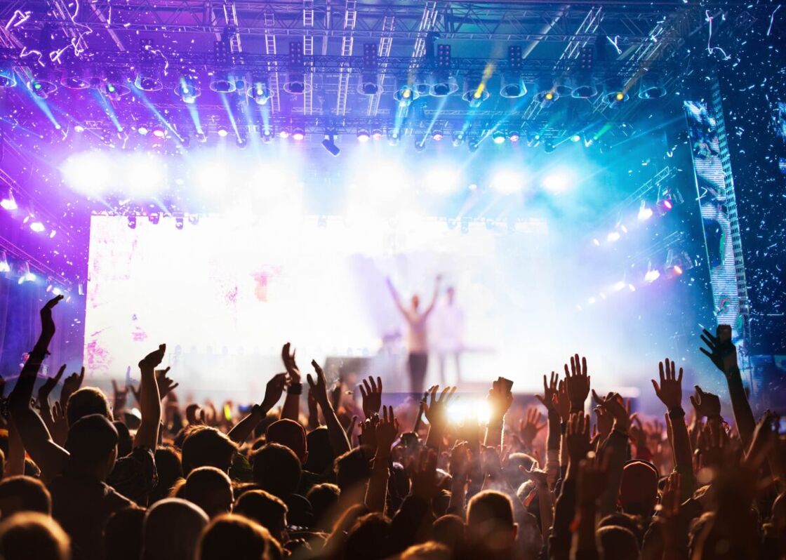 A crowd dances while a band performs.