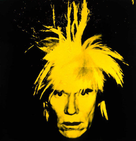 A 1986 yellow self-portrait of Andy Warhol set against a black background.