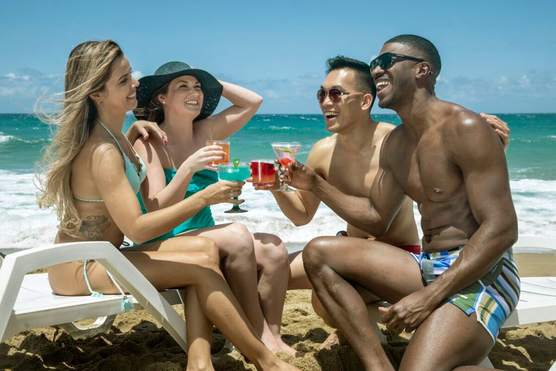 two same-sex couples on the beach in Puerto Rico
