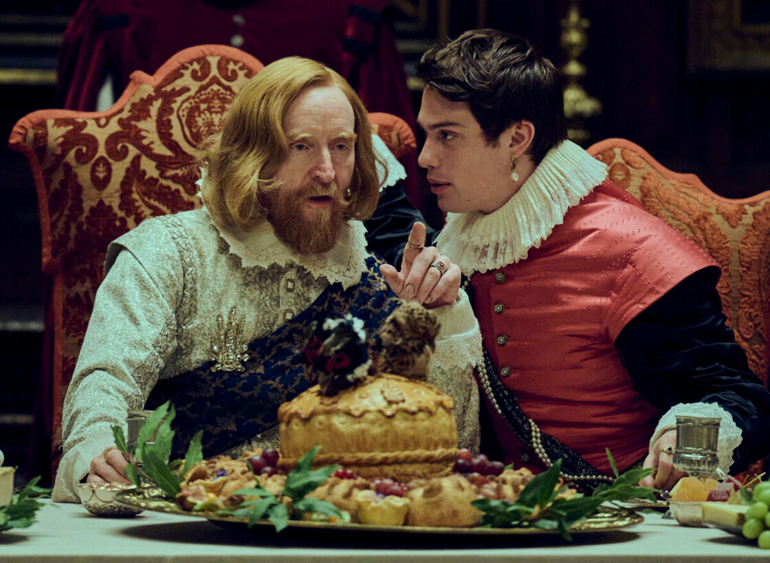 Tony Curran, left and Nicholas Galitzine at a banquet table in a scene from "Mary and George."