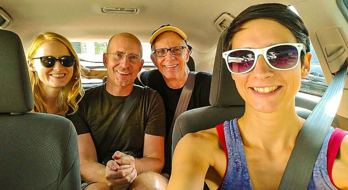 Michael and Brent sit in the backseat of a car along with two female friends. 