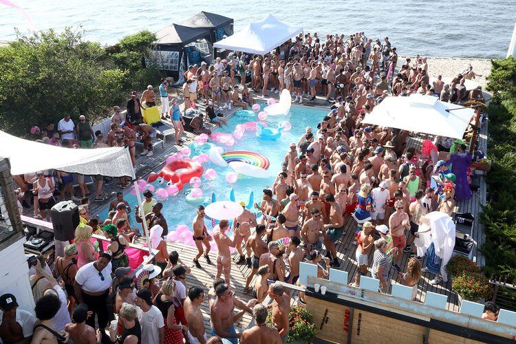 Packed seaside pool party. Photo via Pines Party