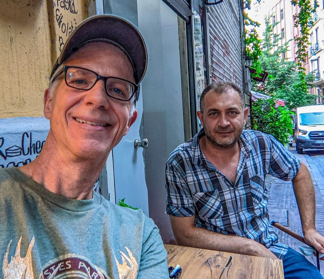 Michael poses for a selfie at a table with a Turkish baker.