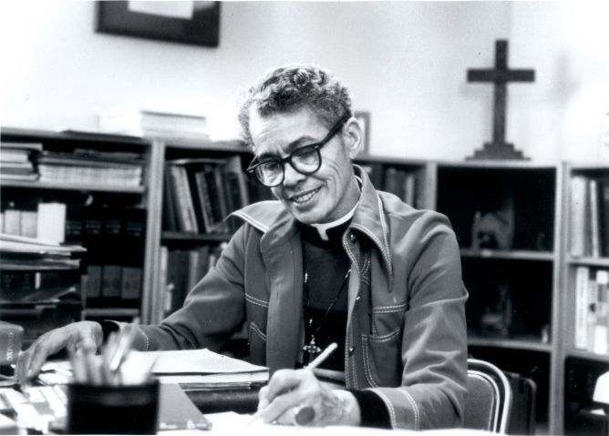 A photograph of Pauli Murray signing a legal paper for civil rights.