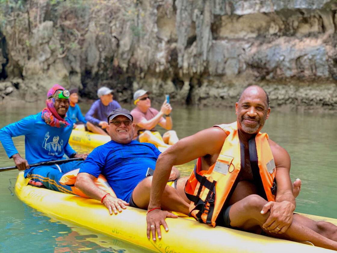 Men kayaking in Thailand as part of Our Adventures' group tour