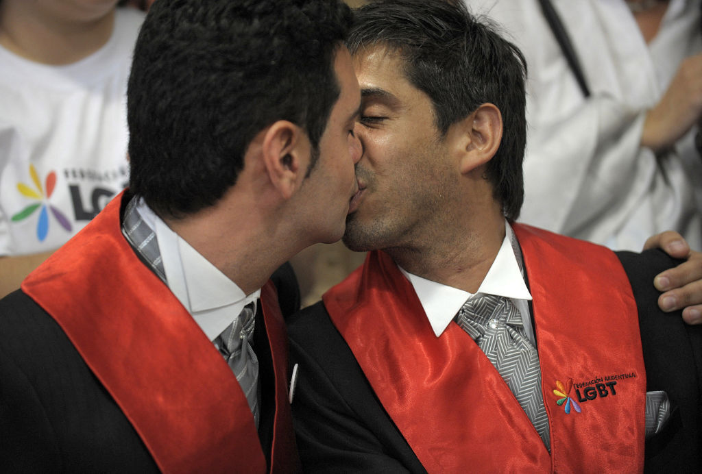Alejandro Freyre (L) and Jose Maria Di Bello (R) kiss during a news conference.