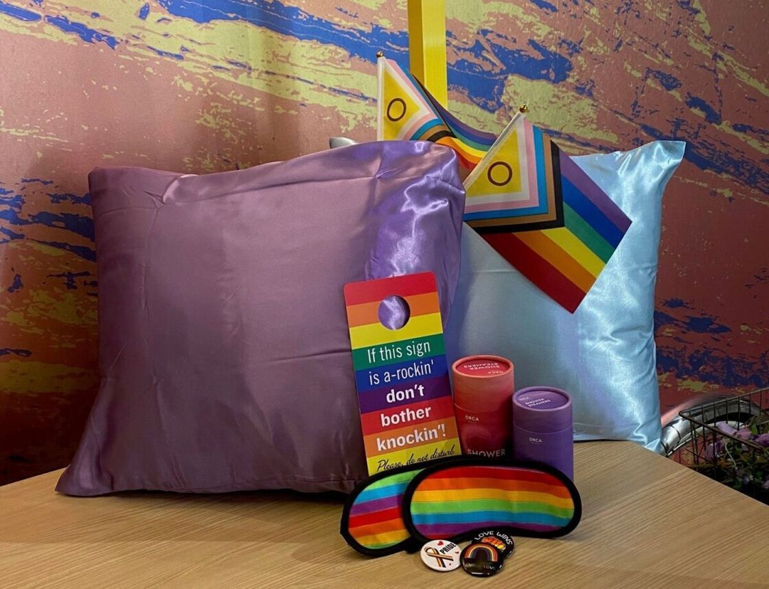Pride package goodies including two silk pillowcases, eye masks and flags. Photo via Curtis Hotel