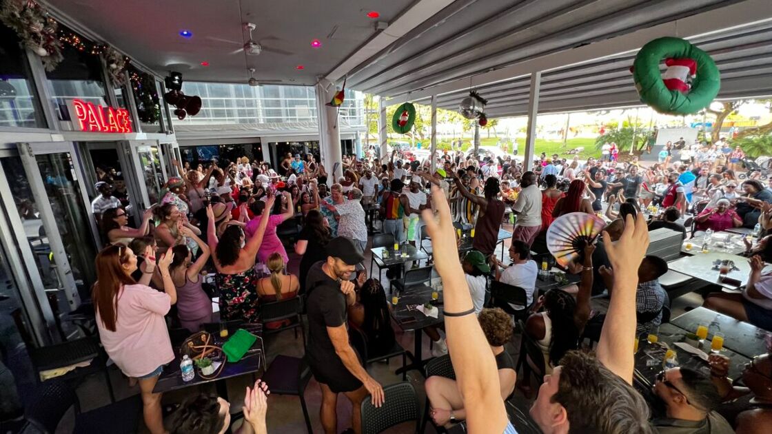 A large crowd of people party on the outside patio