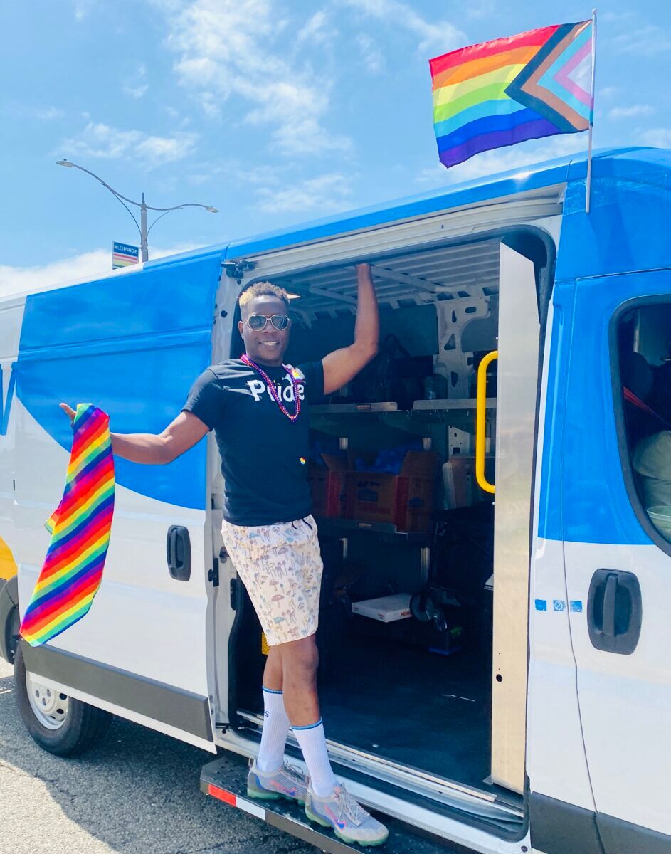 Flag waver in van at Long Beach Pride parade
