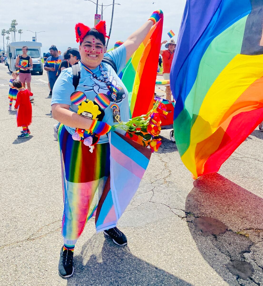 A woman surrounded by rainbow flags 