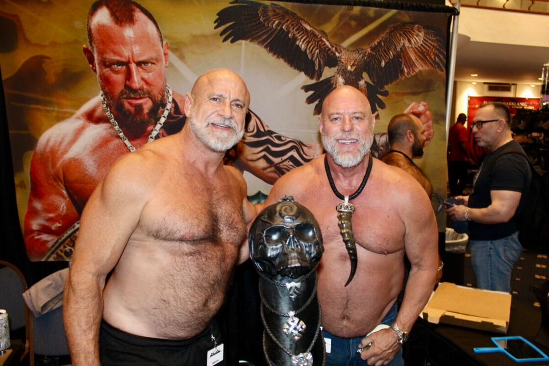 Two shirtless bears strike a muscle pose at IML.
