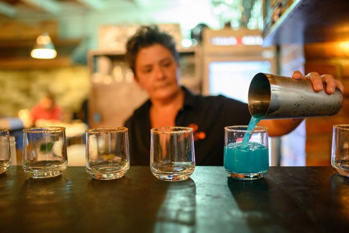 Oculto mixologist Regina Garcia pouring one of her signature drinks.