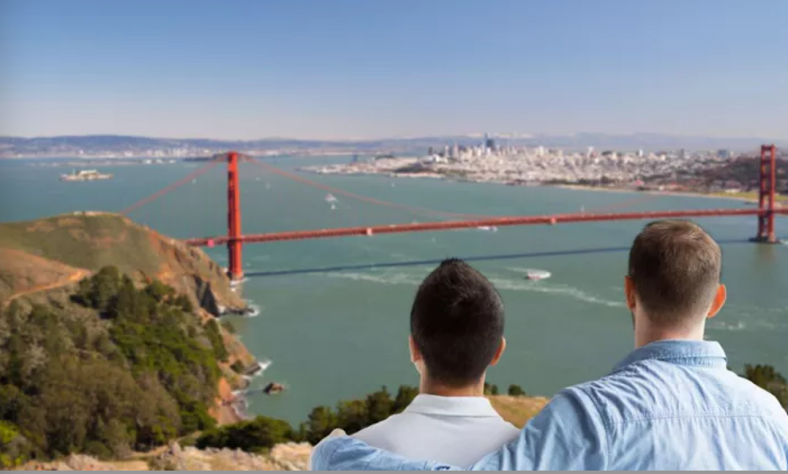 Two men look out over the bay at the Golden Gate Bridge