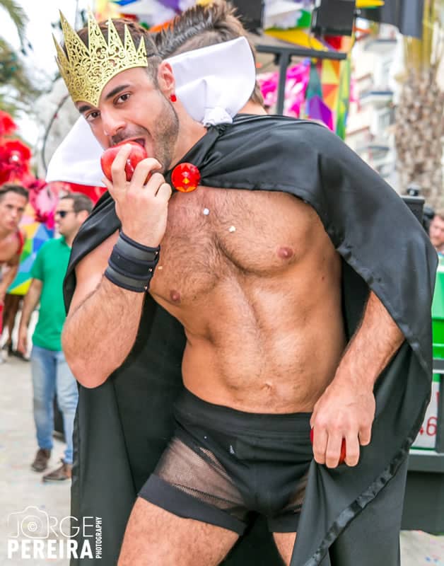 Handsome shirtless man wears a skimpy 'Evil Queen' costume. Photo via Sitges Pride