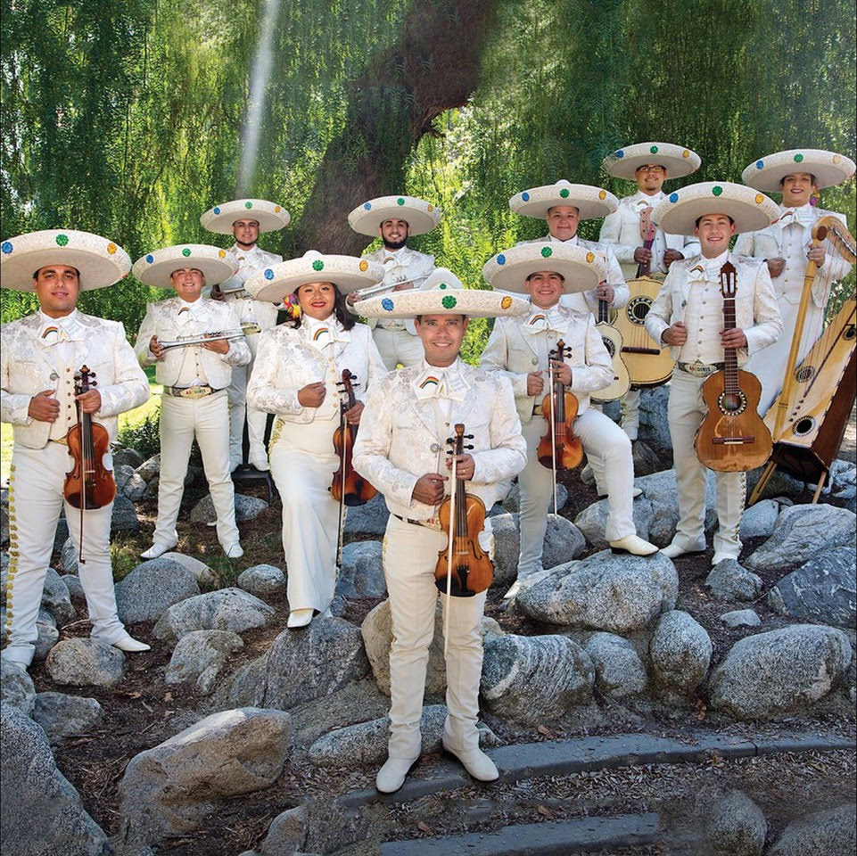 Members of Mariachi Arcoiris de Los Angeles mariachi band stand proudly with their instruments. Photo via Hotel Maya
