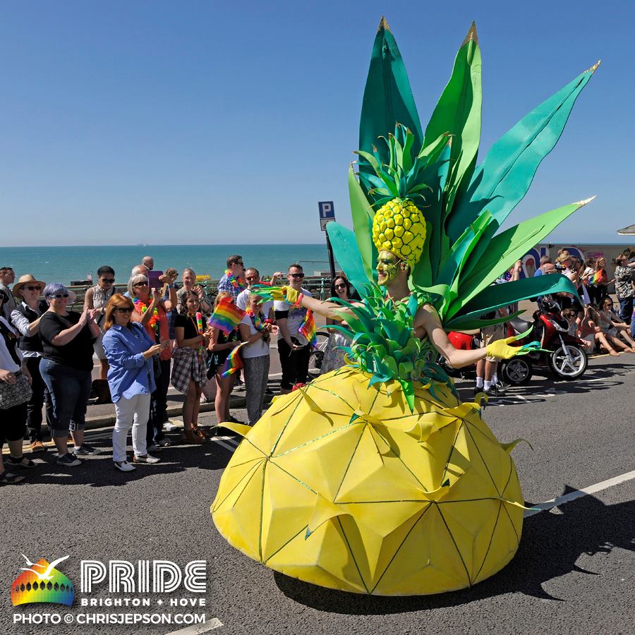 A fabulous pineapple drag costume is shown off to Parade watchers