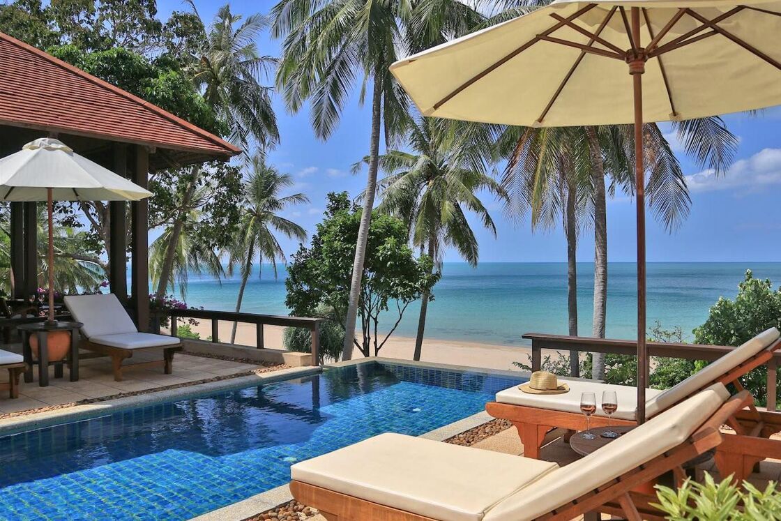 Pool and sunchairs overlooking the ocean. Photo via Pimalai Resort and Spa