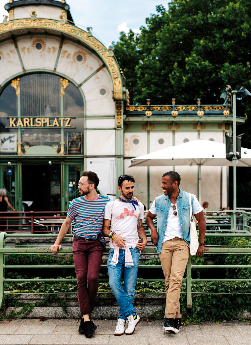 Three gay friends gather at Otto Wagner Pavillon, Karlsplatz, Vienna.