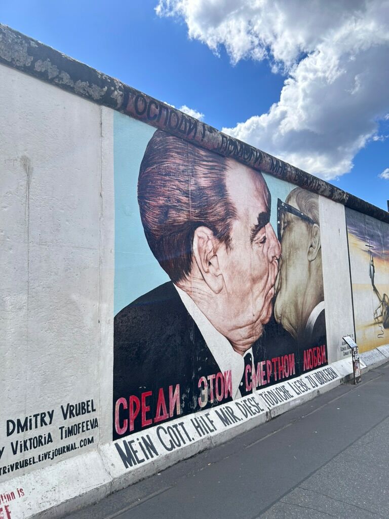 Dictators Leonid Brezhnev and Erich Honecker kiss in a mural painted on the Berlin Wall.