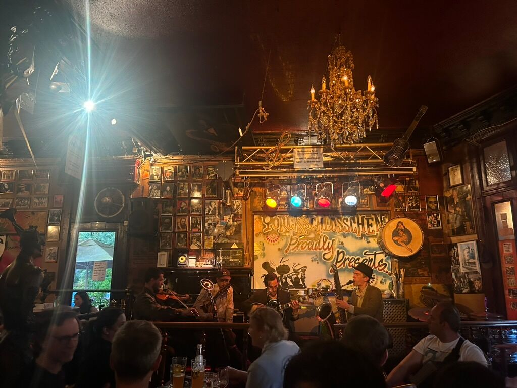 A view of a stage with performers playing music.