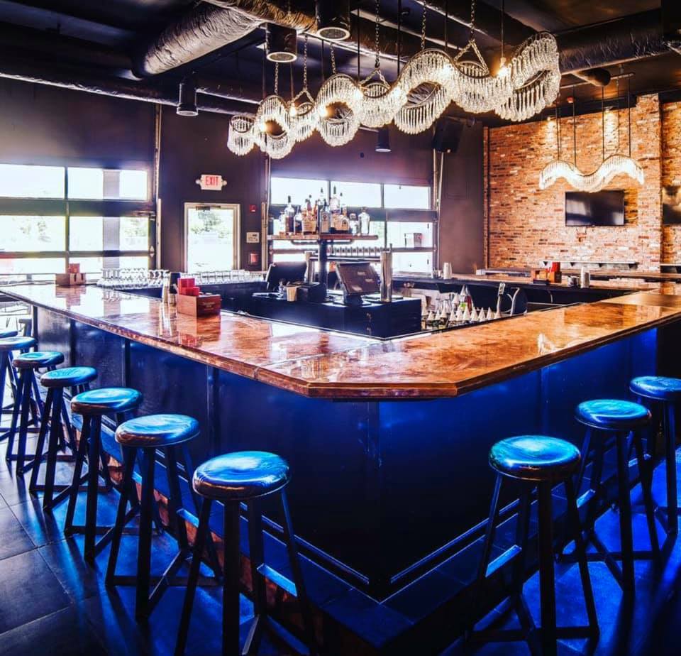 Shining bar with a beautiful crystal chandelier. Photo via Twist Social Club Facebook