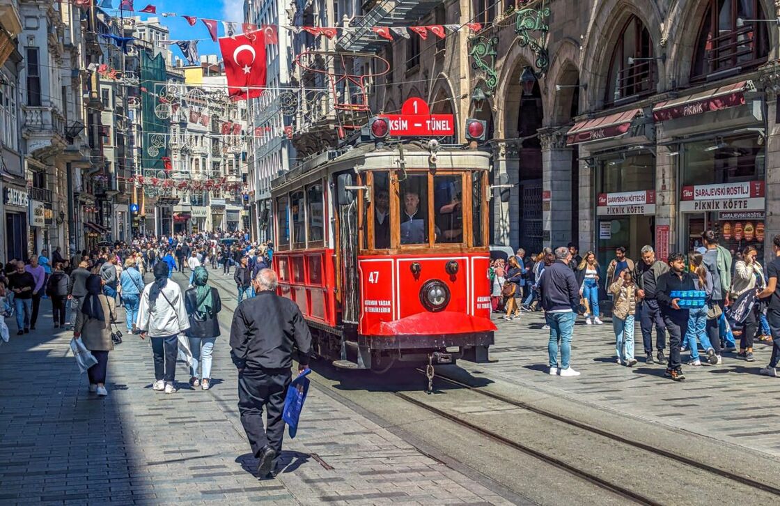 The bright red tram running down a busy Istiklal Street. Be sure to check out the Istiklal Tram, which is soooooooo cute.