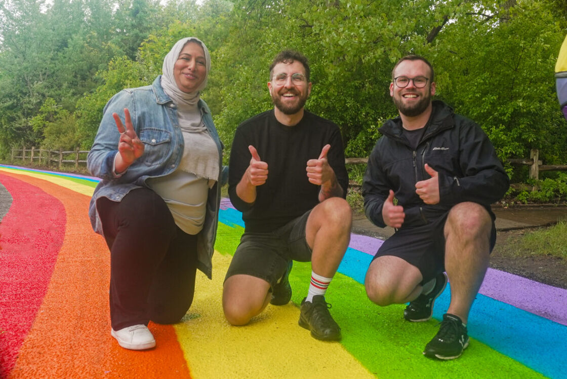 Toronto Deputy Mayor Ausma Malik, Friends of Hanlan's Travis Myers, and Pride Toronto's Bobby MacPherson at Hanlan's Point's rainbow road