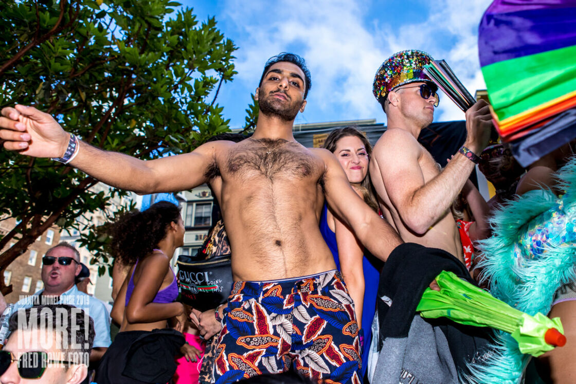 A sexy shirtless man with a hairy chest dances at SF Pride