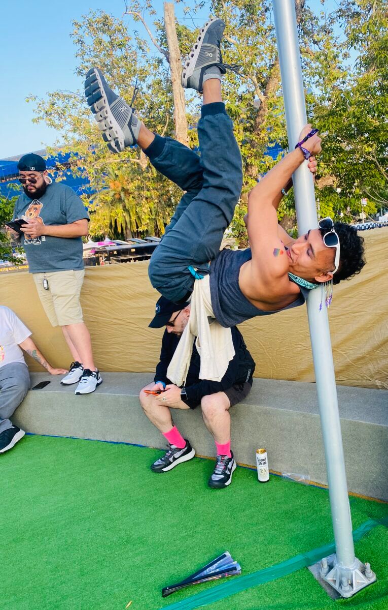 Victor "Hoops" Tang busting out some impromptu pole dancing at WeHo Pride.