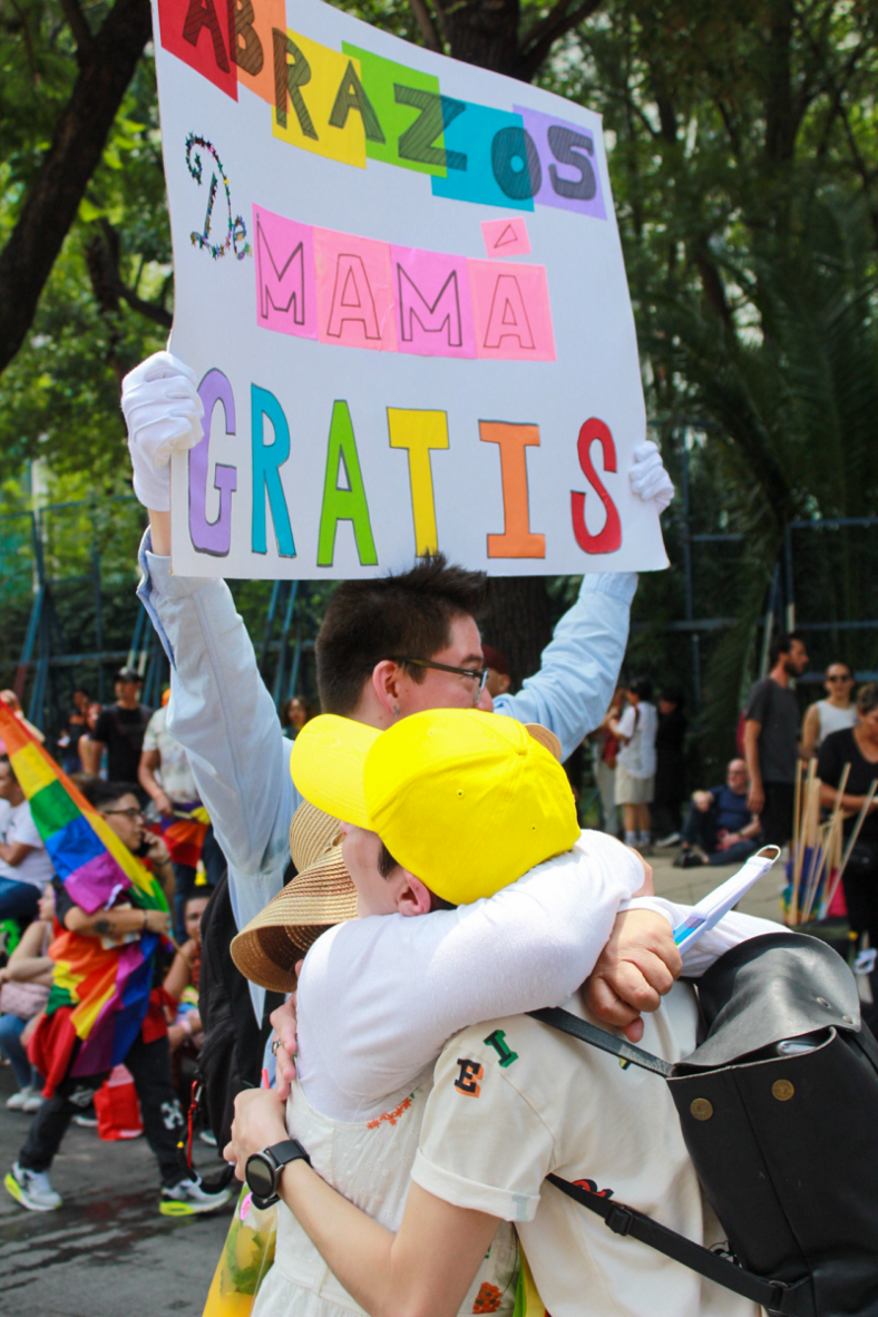 A mom giving free hugs to members of the LGBTQ+ community.