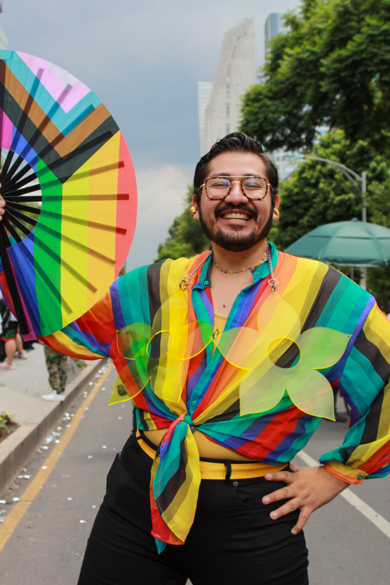 A gay man proud and happy showing off his colorful outfit.