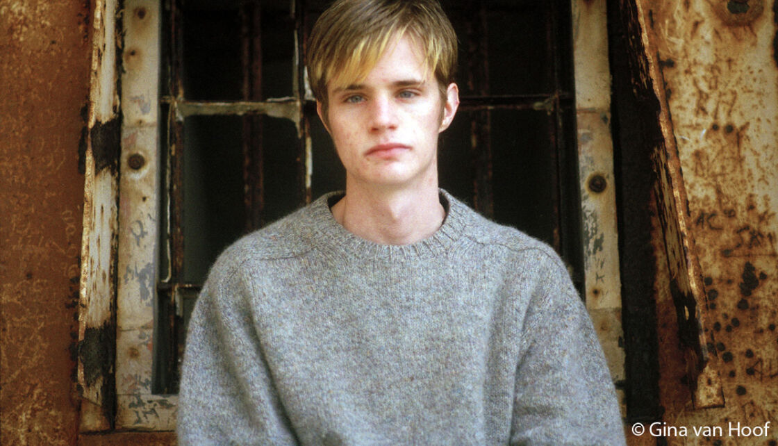 A portrait of Matthew Shepard wearing a grey sweater.