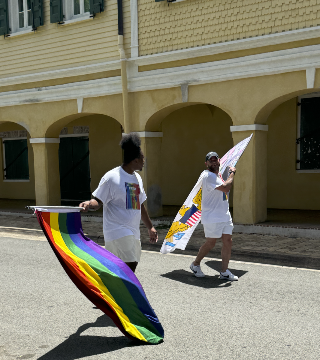Two men waving the Pride flags.