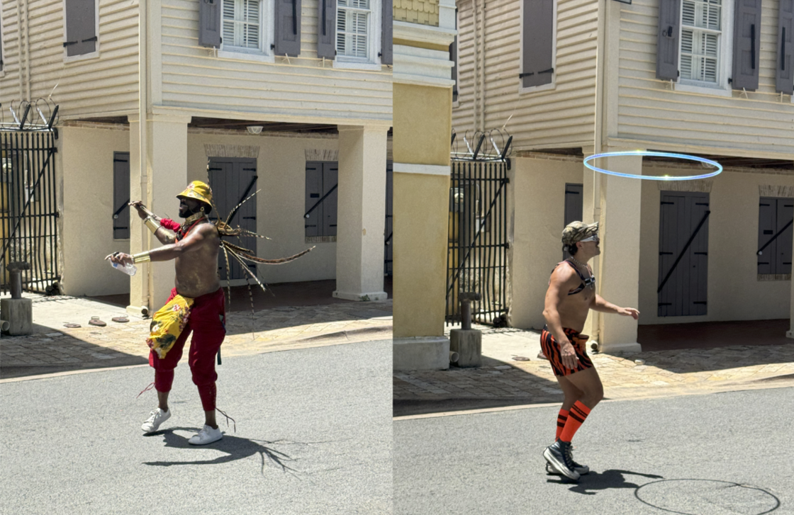 Two shirtless men dance at the St. Croix Pride march. 