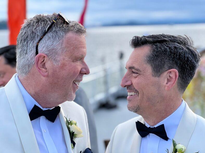 Michael Woody, right, with husband Kevin aboard Seattle's Love For All Boat.