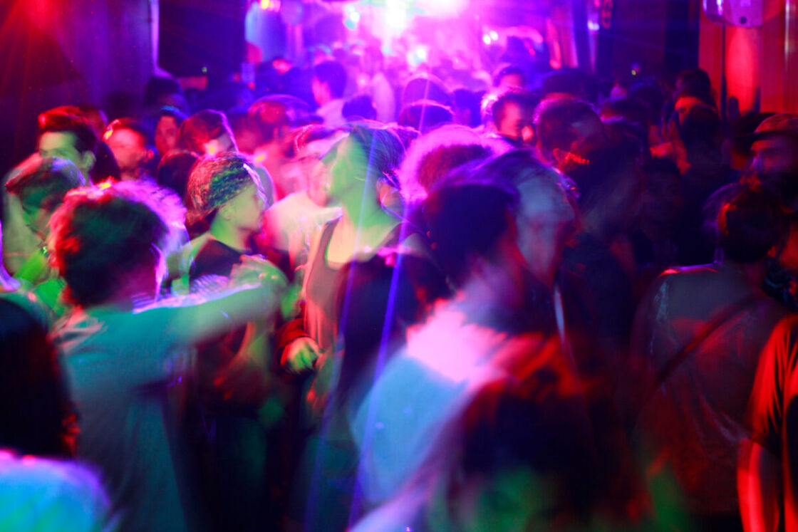 Gay men dancing in a nightclub. 
