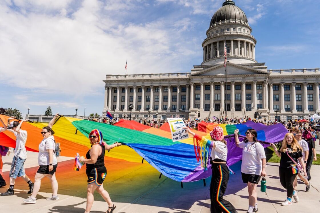 Participants kick off Salt Lake City Pride Month by walking a large Pride flag to the Utah state Capitol. 
