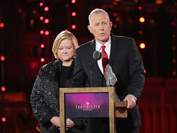 Matthew Shepard's parents making a speech at an award show's podium.