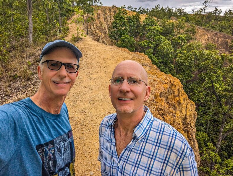 The author and his husband pose for a selfie along a hiking trail in Greece