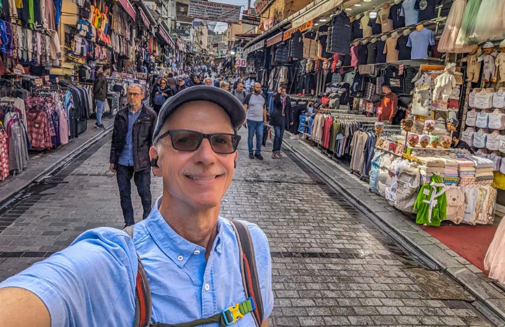 Michael standing on a narrow street market in Istanbul, Turkey. The author standing in a open-air Turkish market