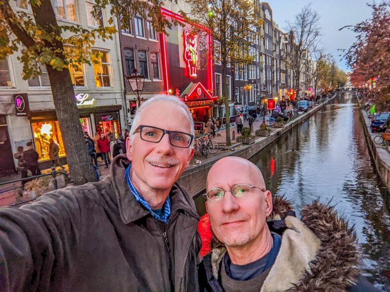 The author and his husband pose for a selfie along a canal in Amsterdam