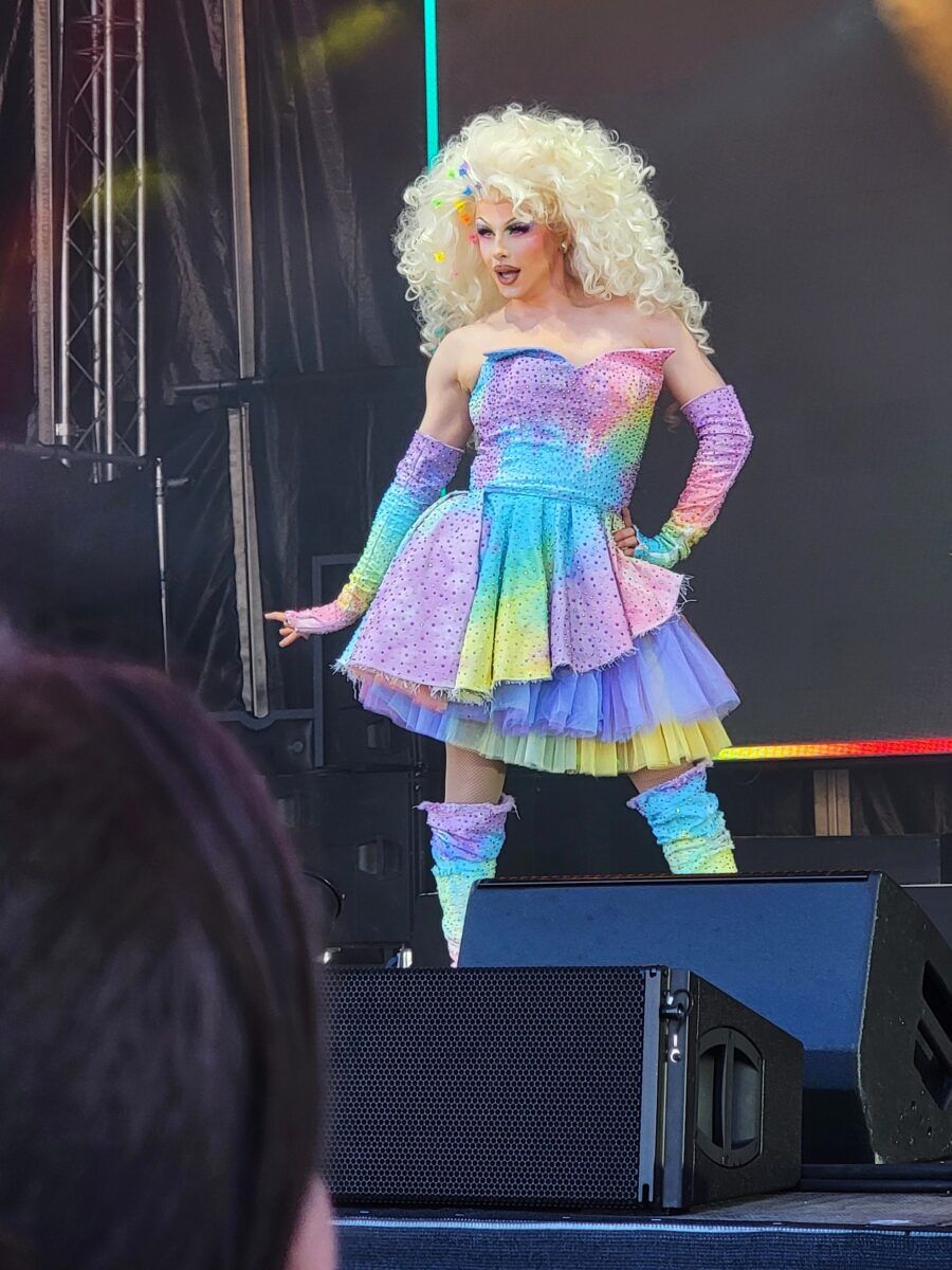 Blu Hydrangea performs on stage in a rainbow colored tutu dress